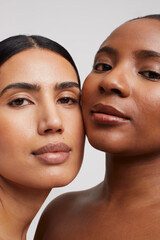 Close-up of two pensive women cheek to cheek