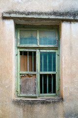 Fototapeta na wymiar Antique old window on loft industrial grunge exterior wall. Old brick walls and window.