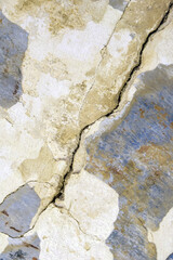 Big deep diagonal crack on old plastered wall. Several of deep cracked line. Close up. Copy space. Selective focus.