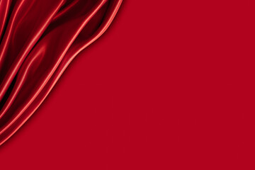 Beautiful elegant wavy hot red satin silk luxury cloth fabric texture with monochrome background design. Wallpaper, banner or card with copy space.