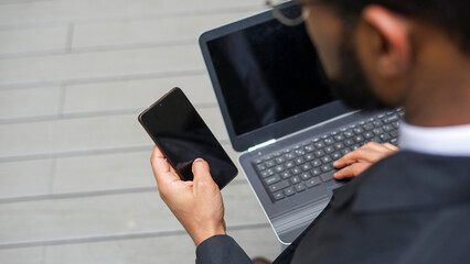 Business man using laptop and mobile phone