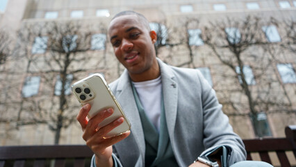 Business man using phone outside office building