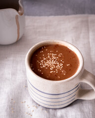 Close up of hot chocolate in a striped mug.