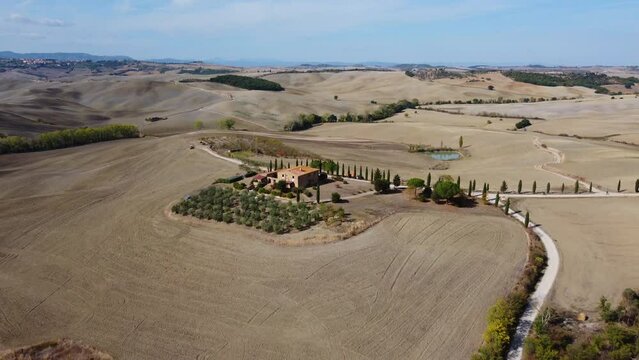 Famous Gladiator cypress road and farmhouse in Val d'Orcia, Pienza Tuscany aerial view, Italy