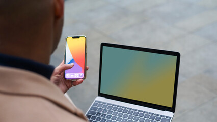 Business man using phone and laptop © Cultura Creative