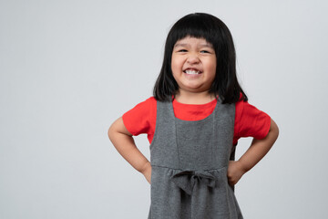 Portrait of happy and funny Asian child girl on white background, a child looking at camera. Preschool kid dreaming fill with energy feeling healthy and good concept