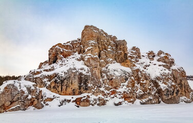 Winter landscape with a large stone from a frozen river © Александр Коликов