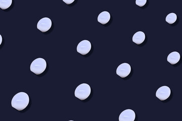 Colorful pattern of chicken eggs on dark blue background. Top view. Flat lay. Pop art design