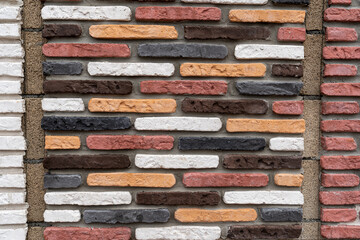 Decor stone cladding plates on the wall. Front exterior and  interior castle facade with ancient old brick stone wall texture pattern in various colors.