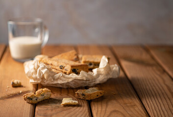 Fototapeta na wymiar Homemade cookies with chocolate, nuts, raisins on a wooden background. Breakfast.