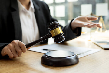 A person holding the hammer of justice, the concept of a lawyer or a law enforcement officer is holding a hammer similar to the judgment of a lawsuit.