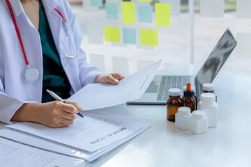 The pharmacist is reviewing the list of drugs and checking the stock of all medicines at one of the pharmacies he owns, his home pharmacy and selling medical supplies. Pharmacy concept.