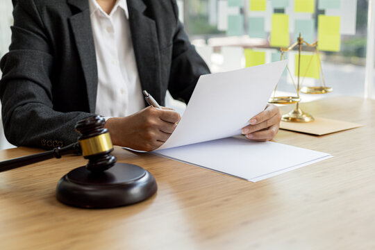 Attorneys are reviewing contract documents for the client, in which the client has filed a lawsuit against an employee at a company that commits the fraud. Fraud litigation concept.