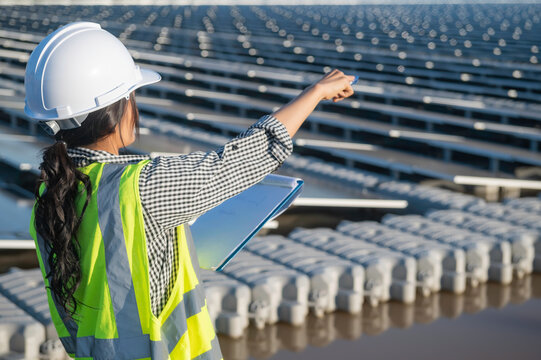 Asian engineer working at Floating solar farm,Renewable energy,Technician and investor solar panels checking the panels at solar energy installation