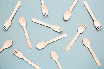 Top view of many wooden fork, spoon, pattern. Natural eco-friendly disposable utensils or creative idea design.