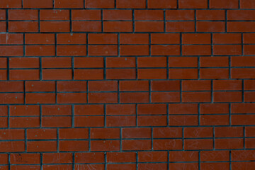 Textured wall made of red brick, with a beautiful texture. The background is a wall of red brick and cement mortar.