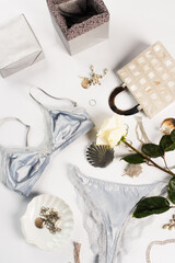 Top view of gift box, bag and lingerie on white background