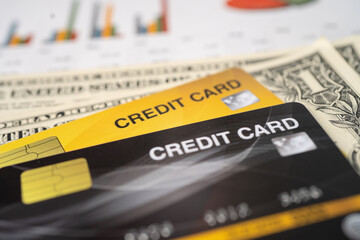 Obraz premium Credit card with US dollar banknote on chart and graph paper. Finance development, Banking Account, Statistics, Investment economy business.