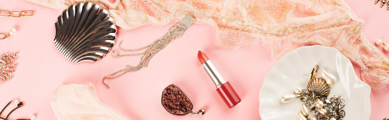 Top view of lipstick near lace lingerie and accessories on pink background, banner