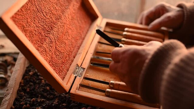 antique retro jewelry box various wood carving tools. close up male hands open box of woodworking tools. vintage cutters scissors. leisure hobby interesting pastime for male. abandoned attic things