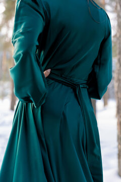 Brunette Woman In An Emerald Green Satin Dress.