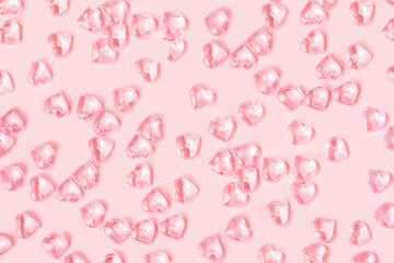 St Valentines day pink monochrome background full frame. Many glass hearts flat lay. Love or wedding concept