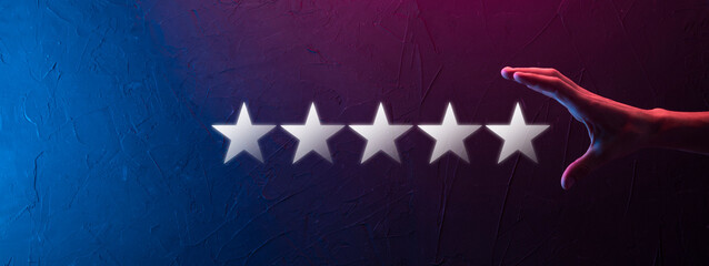 Man holds smart phone in hands and gives positive rating, icon five star symbol to increase rating...