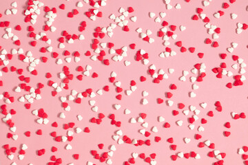 Valentine's Day pattern background. Composition with candy hearts. Symbol heart of sweets on pastel pink background. Flat lay, top view