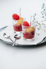 Dessert of grilled rice with raspberries and jam beautifully plated over white
