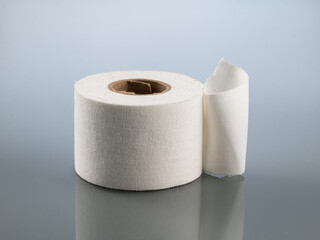 Plaster white in a roll on a gray background