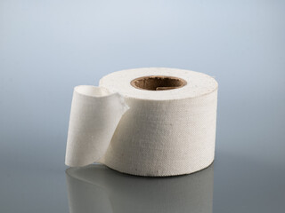 Plaster white in a roll on a gray background