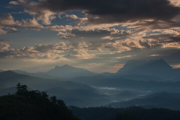 Light beam over a mountain valley with twilight sky in a morning