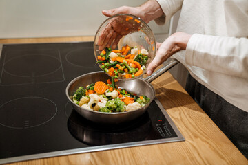 European man making dinner with vegetables in kitchen