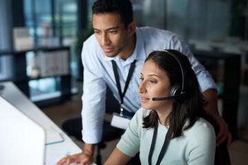 First day in the customer service field. Shot of a young man and woman using a computer while...