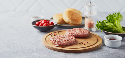 Raw veal mince Burger steak cutlets on wooden cutting board