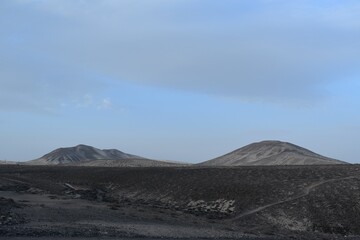 Fototapeta na wymiar Two sandy mountains on the island of Fuerteventura.