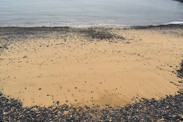 Sand and stone beach on the coast of Fuerteventura