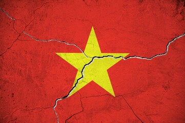 An image of the Vietnam flag on a wall with a crack.