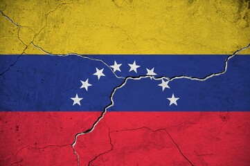 An image of the Venezuela flag on a wall with a crack.