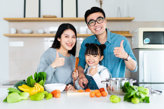 image of an asian family cooking at home