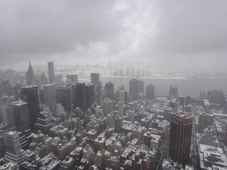 Manhattan - NY, clouded and under snow.