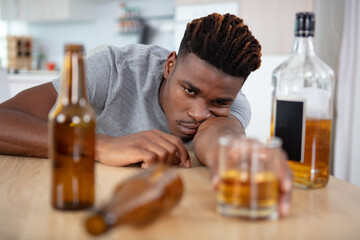 young drunk man is slumped across the table