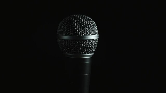 Microphone with moving light on black background