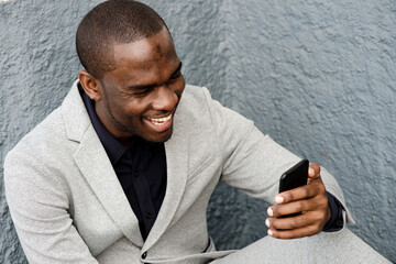 Close up handsome african american man smiling with cellphone