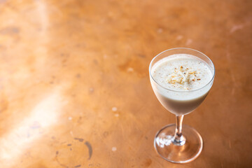 Eggnog rum cocktail with toasted coconut and nutmeg