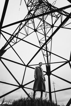 girl under electric line tower