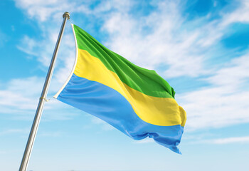 3d rendering Gabon flag waving in the wind on flagpole. Perspective wiev Gabon flag waving a blue cloudy sky