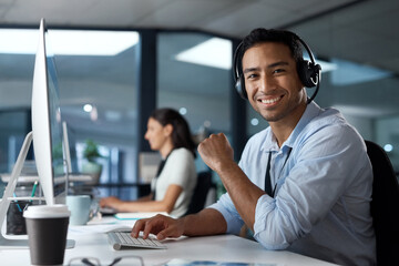 The customer is the real hero of this story. Portrait of a young man using a headset and computer in a modern office.