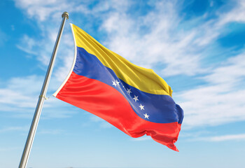 3d rendering Venezuela flag waving in the wind on flagpole. Perspective wiev Venezuela flag waving a blue cloudy sky