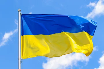 Fotobehang The state flag of Ukraine on a background of blue sky © olegdubyna